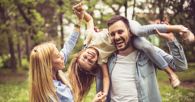 Happy, healthy family smiling together at home, representing the benefits of natural dietary supplements for overall wellness, immune support, mood balance, and daily health using mushroom and saffron supplements.